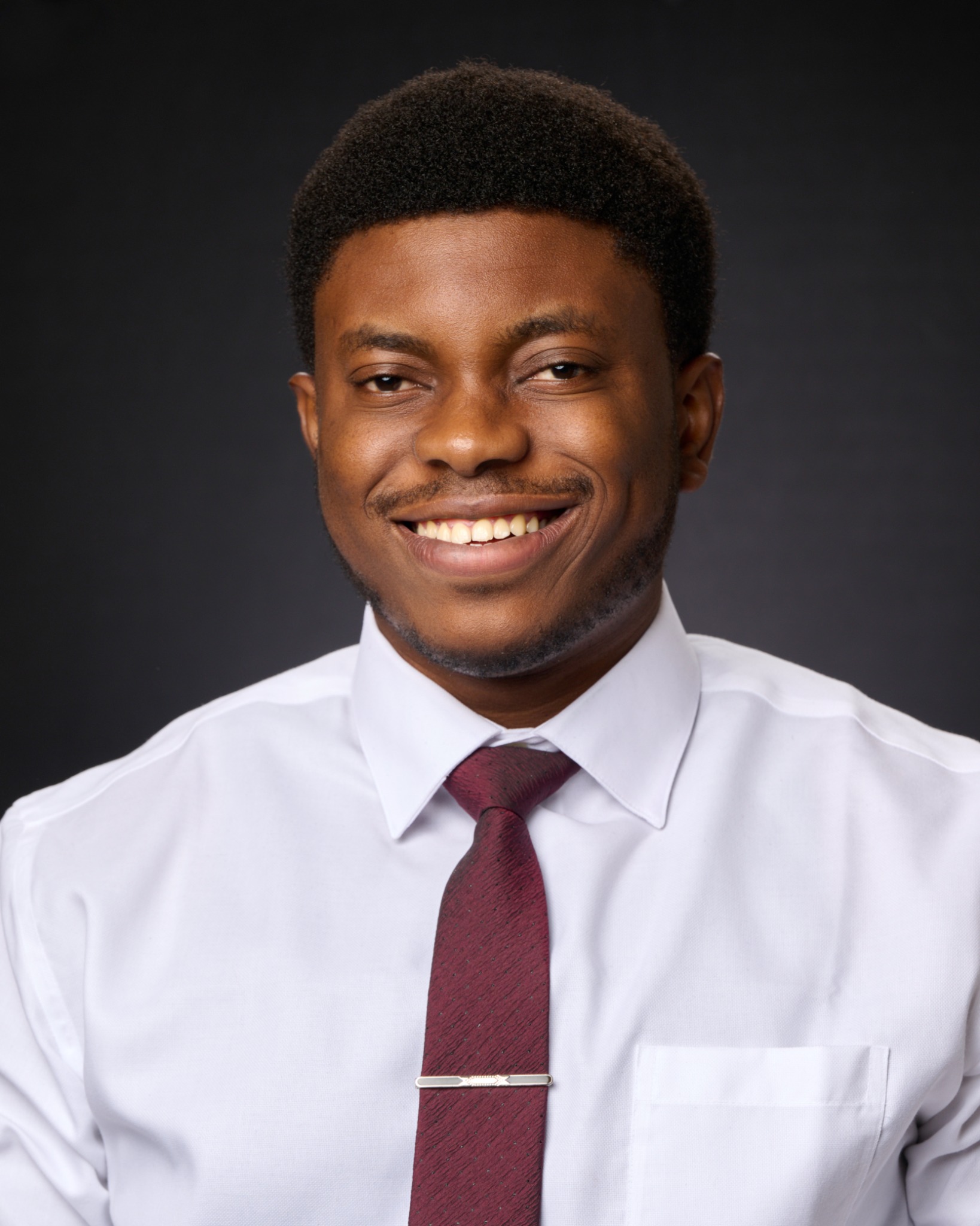 Professional headshot of John Salako